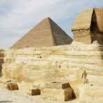 GIZA, EGYPT - NOVEMBER 13: Tourists marvel at the Sphinx while Khufu pyramid looms behind November 13, 2004 at Giza, just outside Cairo, Egypt. The three large pyramids at Giza, built by King Khufu over a 30 year period around 2,550 B.C., are among Egypt's biggest tourist attractions.  (Photo by Sean Gallup/Getty Images)